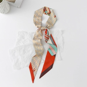 Detail of floral chain pattern on narrow faux silk scarf with elegant bias-cut ends