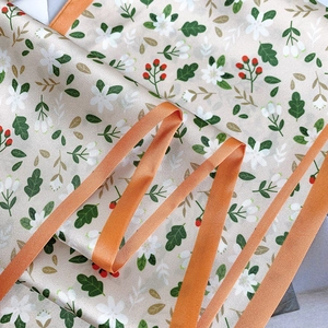 Detail of floral ink painting silk scarf with elegant orange satin border finish