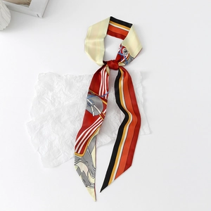 Detailed view of silk-like twilly scarf with horse prints and colorful stripes
