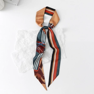 Detail of floral silk twilly scarf with geometric and equestrian patterns on white paper