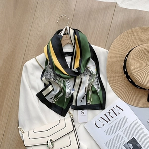 Detail of silk scarf with zebra print and color block pattern on white blazer