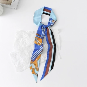 Close-up of a blue striped silk twilly scarf featuring elegant horse and harness patterns