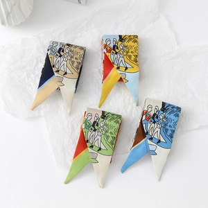 Close-up of four colorful skinny twilly scarves with artistic cartoon character patterns
