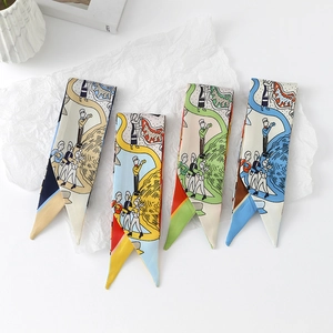 Flat lay of multiple floral print twilly silk scarves on minimalist textured paper