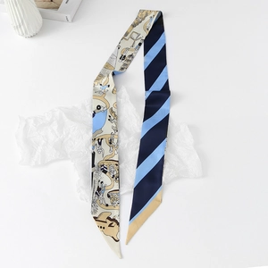 Detail of a double-sided floral twilly scarf with blue stripes and beige illustration