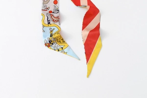 Detail of floral twilly scarf with cartoon illustration and colorful diagonal stripes