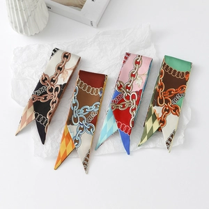 Detailed view of four narrow floral silk-like scarves in geometric and chain patterns