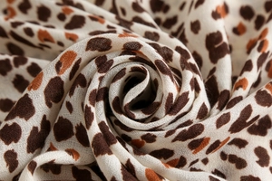 Detailed macro view of the leopard print linen-cotton fabric showing fine woven texture