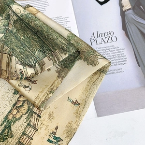Macro detail of high-quality silk scarf featuring vintage garden ink landscape prints