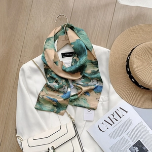 Artistic oil painting silk-like scarf with green landscape print on a beige blazer