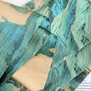 Detailed close-up of mountain ink print silk scarf with elegant satin luster and texture
