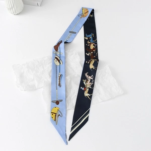 Detail of floral and polo themed silk scarf with blue double-sided design and equestrian motifs