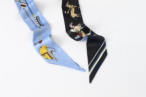 Close-up of two elegant equestrian style floral twilly scarves with silky satin texture
