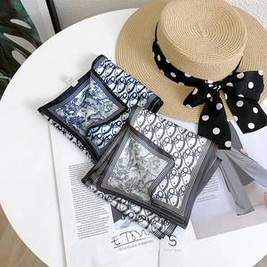 Detail view of elegant double-layered patterned silk scarves on a bright table