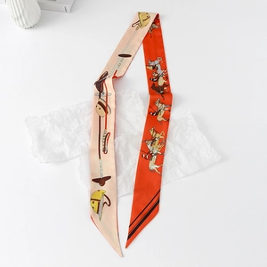 Close-up of double-sided twilly silk scarf featuring equestrian motifs and orange pattern