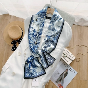 Blue and white Toile de Jouy silk scarf paired with a white blazer and accessories
