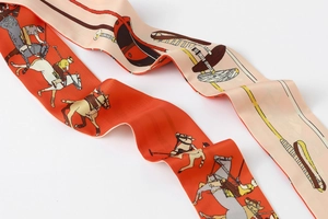 Detailed macro view of long silk twilly scarf with elegant equestrian polo pattern design