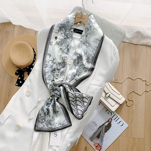 Detail shot of black and white printed silk scarf with classic toile de jouy pattern