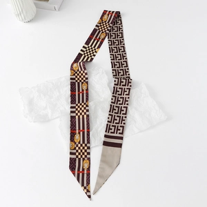 Flat lay of floral silk scarf ribbon with chain patterns on elegant white background