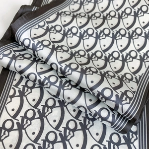 Close-up of luxury faux silk scarf with elegant digital ink print and geometric patterns