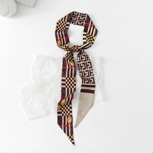 Detail of floral skinny scarf with horsebit pattern and smooth silk-like texture