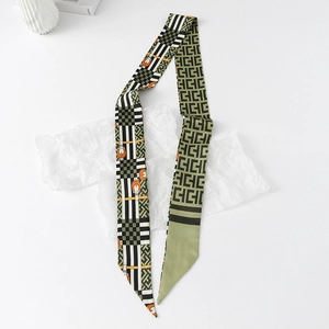 Close-up of geometric floral silk ribbon scarf with horsebit print on white background