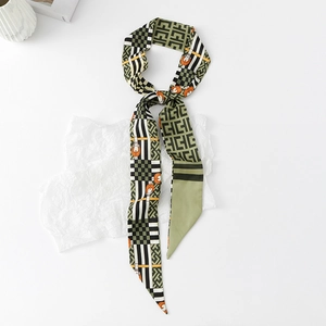 Detail view of floral twilly scarf with geometric patterns and orange strap accents