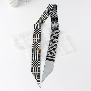 Macro detail of silky twilly scarf with checkerboard and vintage horsebit patterns