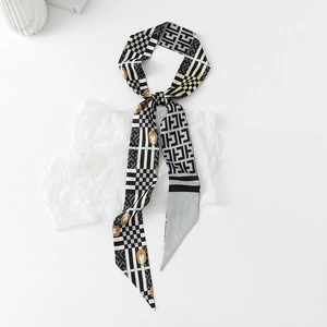Close-up of narrow silk ribbon scarf with black and white F-pattern and horsebit design