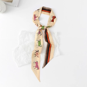 Close-up of beige twilly scarf featuring horse silhouettes and classic vertical stripes