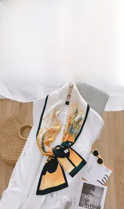 Sciarpa in seta vintage stile pittura a olio annodata su un blazer bianco raffinato
