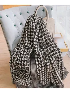 Detail of soft houndstooth cotton linen scarf draped on a sofa for an elegant home look