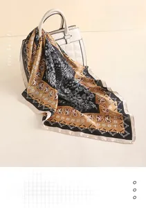 Detail of 70x70cm paisley silk-like scarf draped over a handbag in elegant neutral tones