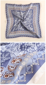 Detail of lavender satin scarf featuring paisley patterns and smooth silk texture