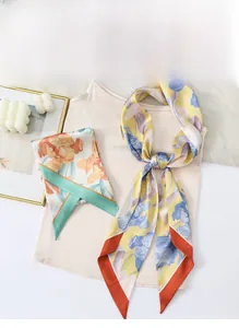 Detailed close-up of floral print satin scarves showing smooth texture and elegant patterns