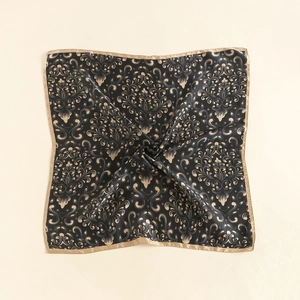 Macro shot of silk square scarf featuring gold damascus floral pattern and smooth satin texture