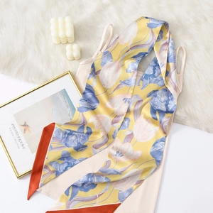 Floral print satin skinny scarf with blue tulips and orange border on plush background