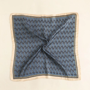 Detail of vintage equestrian square silk scarf with paisley pattern and golden borders