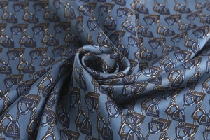 Detail of grey-blue silk satin scarf featuring elegant stirrup and rope pattern prints