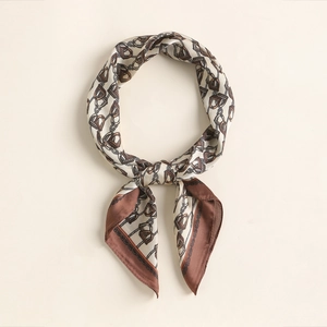 Macro shot of retro equestrian scarf with horsebit and chain prints and hand-rolled edges