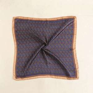 Detailed texture of silk square scarf featuring equestrian horsebit and chain patterns