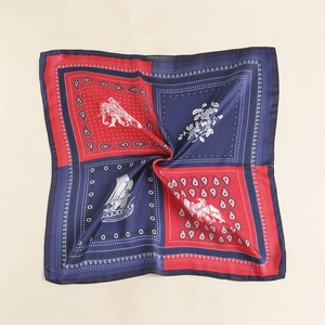 Detailed fold view of vintage square silk scarf with paisley and red-blue patterns