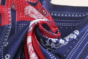 Close-up of silk-like paisley pattern square scarf with elegant golden edges