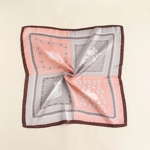 Detail view of square paisley silk scarf showing pink and grey patchwork with floral patterns