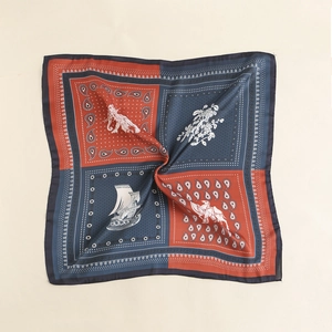 Detailed view of square silk scarf with paisley, floral prints and contrast border
