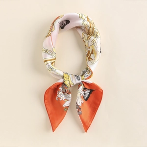Detail of silk square scarf featuring floral patterns and butterflies with a soft luster