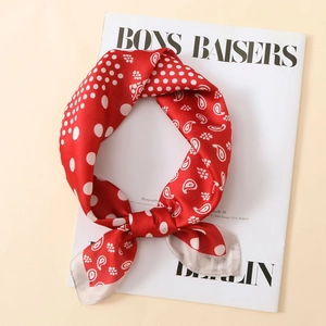 Foulard quadrato di seta rossa e bianca a pois e paisley su una rivista di moda