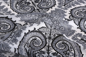 Detail of paisley silk scarf featuring elegant black and white floral pattern texture