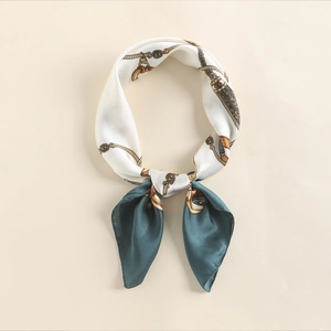 Close-up of elegant silk square scarf with vintage golden chain and belt pattern