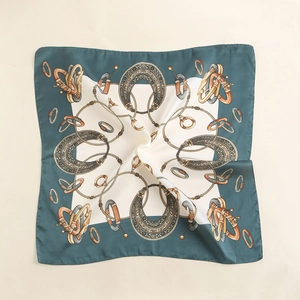 Detailed view of square silk scarf with vintage equestrian print and golden chain pattern